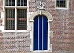 Colorful blue door from the Groot Begijnhof. &nbsp;Inscription in the lintel says "Inden Berch Thabor 1649", and above that there is a low relief carving of Jesus (rising from the dead?)