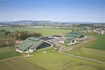 An aerial view of the Evergreen Aviation & Space Musuem campus. &nbsp;The Aviation Building is to the left, the Space Building to the right, and the IMAX theater is the smaller building in the middle and slightly in front of the other two. &nbsp;This photo is courtesy of the Airport Journals www.airportjournals.com. &nbsp;I cropped, sharpened and adjusted the color and contrast.